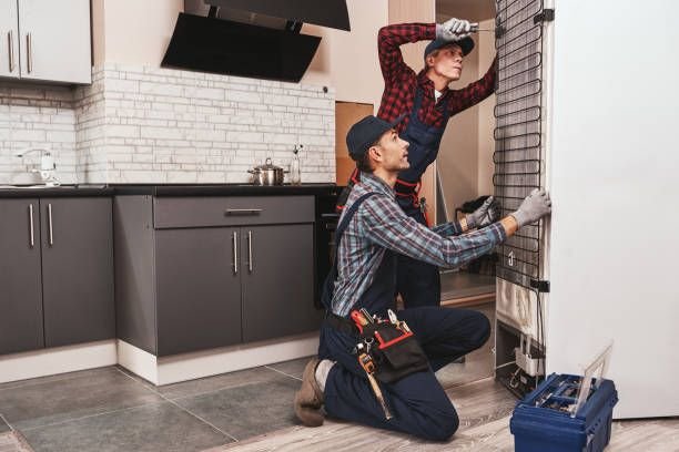 workers repairing refrigerator